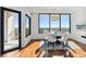 Dining room boasts hardwood floors, modern lighting, and access to the balcony at 2828 Peachtree Nw Rd # 1502, Atlanta, GA 30305
