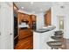 A modern kitchen with wooden cabinets, black countertops, and a bar area with stylish seating at 2828 Peachtree Nw Rd # 1502, Atlanta, GA 30305