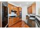 This kitchen offers granite countertops, a cooktop, oven, microwave and refrigerator at 2828 Peachtree Nw Rd # 1502, Atlanta, GA 30305