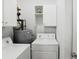 Efficient laundry room with a washer and dryer, plus storage cabinets for convenience at 2828 Peachtree Nw Rd # 1502, Atlanta, GA 30305