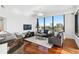 Bright living room features hardwood floors, large windows, and city views at 2828 Peachtree Nw Rd # 1502, Atlanta, GA 30305