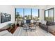 Sunlit living room featuring expansive windows, city views, and comfortable seating at 2828 Peachtree Nw Rd # 1502, Atlanta, GA 30305