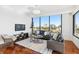 Bright living room features hardwood floors, large windows, and city views at 2828 Peachtree Nw Rd # 1502, Atlanta, GA 30305