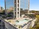 Aerial view of a rooftop pool with lounge chairs and greenery against a building backdrop at 2828 Peachtree Nw Rd # 1502, Atlanta, GA 30305