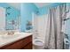 Bright bathroom featuring blue walls, a shower with a curtain, and vanity with a sink at 4040 Brightmore Dr, Austell, GA 30106