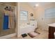 Bright bathroom featuring a soaking tub, a separate shower, and a large window for natural light at 4040 Brightmore Dr, Austell, GA 30106