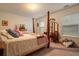 Bedroom with four-poster bed, dresser, and natural light at 4040 Brightmore Dr, Austell, GA 30106