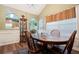 Dining area with a dark wood table, chairs, and decorative cabinet seen through arched entryway at 4040 Brightmore Dr, Austell, GA 30106
