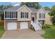 Charming split-level home featuring a brick facade, two-car garage, and welcoming front staircase at 4040 Brightmore Dr, Austell, GA 30106