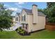 Side view of a split-level house, displaying the brick foundation and well-kept landscaping at 4040 Brightmore Dr, Austell, GA 30106