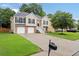 Inviting two-story home with a well-manicured lawn and a spacious driveway leading to a two-car garage at 4040 Brightmore Dr, Austell, GA 30106
