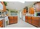 Bright kitchen with wooden cabinets, white appliances, tile floors, and natural light through the window at 4040 Brightmore Dr, Austell, GA 30106