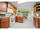 Well-lit kitchen featuring warm wood cabinets, tile flooring, and a breakfast nook with a skylight at 4040 Brightmore Dr, Austell, GA 30106
