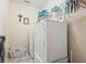 Efficient laundry room with white washer and dryer, complemented by storage shelves at 4040 Brightmore Dr, Austell, GA 30106