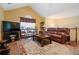 Cozy living room with vaulted ceilings, a leather sofa, and a warm, inviting ambiance for relaxation at 4040 Brightmore Dr, Austell, GA 30106