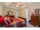 Comfortable main bedroom with a ceiling fan, trey ceiling, dresser, and cozy bed at 4040 Brightmore Dr, Austell, GA 30106