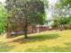 A green backyard with a red brick home and steps leading up to the back of the house at 1558 Boulderwoods Se Dr, Atlanta, GA 30316