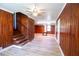 Rustic basement with wood paneled walls, laminate flooring, and wooden stairs at 1558 Boulderwoods Se Dr, Atlanta, GA 30316