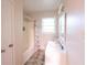 Bathroom with updated vanity, patterned shower curtain, and a bright window at 1558 Boulderwoods Se Dr, Atlanta, GA 30316