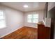 Bedroom features hardwood floors, two windows allowing natural light, and neutral paint at 1558 Boulderwoods Se Dr, Atlanta, GA 30316
