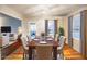 Dining room with hardwood floors, table set for six, and view into the living room at 1558 Boulderwoods Se Dr, Atlanta, GA 30316