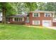 Charming two-story red brick home with white shutters and a well-manicured lawn at 1558 Boulderwoods Se Dr, Atlanta, GA 30316