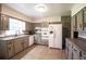 Kitchen with painted cabinets, neutral countertops, and updated appliances at 1558 Boulderwoods Se Dr, Atlanta, GA 30316
