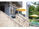 Stairway leading to Perc Restaurant, with umbrellas and outdoor seating visible at 1558 Boulderwoods Se Dr, Atlanta, GA 30316