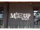 Exterior view of Mix'D UP Burgers signage on a brick wall at 1558 Boulderwoods Se Dr, Atlanta, GA 30316