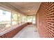 Enclosed sunroom with brick accent wall offering additional relaxation space at 1558 Boulderwoods Se Dr, Atlanta, GA 30316