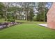 Spacious backyard with lush green lawn, landscaping, and wooded backdrop at 298 Saint Marys Nw Ln, Marietta, GA 30064