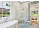 Bathroom with a freestanding tub, glass shower, and patterned tile floor next to the bedroom at 298 Saint Marys Nw Ln, Marietta, GA 30064