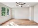 An empty bonus bedroom with hardwood floors, a ceiling fan, natural light and white walls at 298 Saint Marys Nw Ln, Marietta, GA 30064