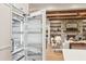 Stainless steel fridge with open door, stone fireplace and living room in background at 298 Saint Marys Nw Ln, Marietta, GA 30064