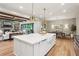 Bright kitchen with large island, stone fireplace and view to dining room at 298 Saint Marys Nw Ln, Marietta, GA 30064