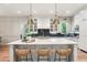Modern kitchen island features a white countertop with stylish pendant lighting and wicker stools at 298 Saint Marys Nw Ln, Marietta, GA 30064