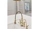 Close-up of the kitchen faucet, which is an elegant gold color at 298 Saint Marys Nw Ln, Marietta, GA 30064