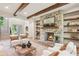 Cozy living room with stone fireplace, built-in shelving, and views of the grand staircase at 298 Saint Marys Nw Ln, Marietta, GA 30064