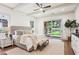 Bright main bedroom with a ceiling fan and an outdoor fireplace viewed through sliding glass doors at 298 Saint Marys Nw Ln, Marietta, GA 30064