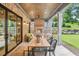 Inviting covered patio with brick fireplace and comfortable seating area at 298 Saint Marys Nw Ln, Marietta, GA 30064