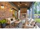 Covered patio with brick fireplace, outdoor seating, and manicured lawn at 298 Saint Marys Nw Ln, Marietta, GA 30064