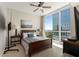 Bedroom with hardwood furniture, ceiling fan, and city view at 3325 Piedmont Ne Rd # 2006, Atlanta, GA 30305