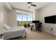 Bright bedroom with a ceiling fan, desk, and large window with city views at 3325 Piedmont Ne Rd # 2006, Atlanta, GA 30305