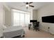 Bedroom with a ceiling fan, desk, and large window at 3325 Piedmont Ne Rd # 2006, Atlanta, GA 30305