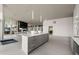 Open layout kitchen with white countertops and stainless steel appliances open to a large living space with fireplace at 3325 Piedmont Ne Rd # 2006, Atlanta, GA 30305