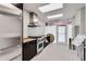 Galley kitchen with stainless steel appliances, dark brown cabinets, light countertops, and a door to the outside at 3325 Piedmont Ne Rd # 2006, Atlanta, GA 30305