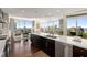 Open kitchen features dark cabinetry, stainless steel appliances, and large windows with scenic views at 3325 Piedmont Ne Rd # 2006, Atlanta, GA 30305