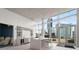 Bright kitchen with modern island, light countertops, cityscape view from large windows, and stainless steel appliances at 3325 Piedmont Ne Rd # 2006, Atlanta, GA 30305