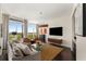 Bright living room with floor-to-ceiling windows, modern furnishings, and dark wood flooring at 3325 Piedmont Ne Rd # 2006, Atlanta, GA 30305
