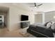 This main bedroom features a ceiling fan, large TV, and neutral carpeting at 3325 Piedmont Ne Rd # 2006, Atlanta, GA 30305